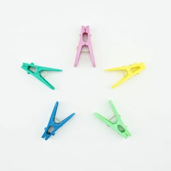 Clothes Pegs put like colourful of star on white background.