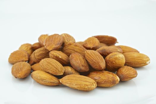 Crispy almond baked without hull isolated placed on white background.