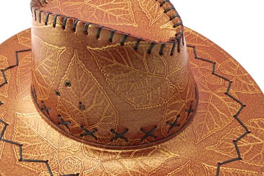 Brown cowgirl hat with flower and leaves tracery
on a white background.