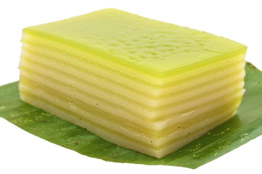 Thai layer cake on a banana leaf green isolated with white background.