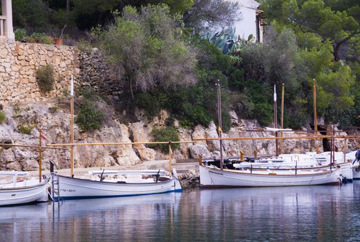 CALA FIGUERA, MALLORCA, BALEARIC ISLANDS, SPAIN ON NOVEMBER 3 2013: Small Majorquin boats (llauts) moored in small harbor on November 3 2013, in Cala Figuera, Mallorca, Balearic islands, Spain.