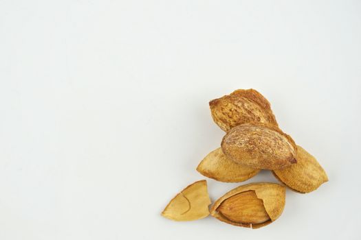Almond with hull and almond husk isolated on white background.