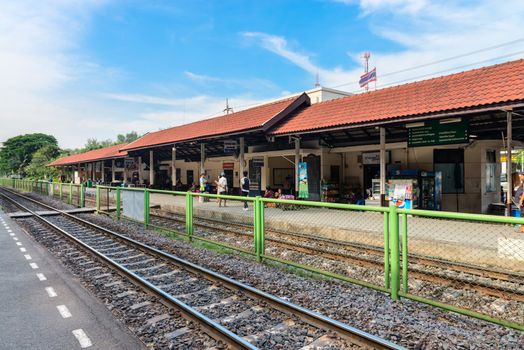 DONG MUEANG, THAILAND - 21 NOV 2013: Railway station with people on outdoor platforms