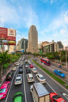 BANGKOK, THAILAND - 21 NOV 2013: Traffic jam on the city streets with billboards, modern buildings in rush hour and skyscrapers on background