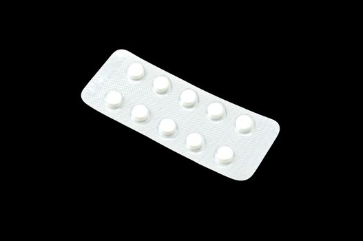 White tablets in the silver panel isolated on black background.