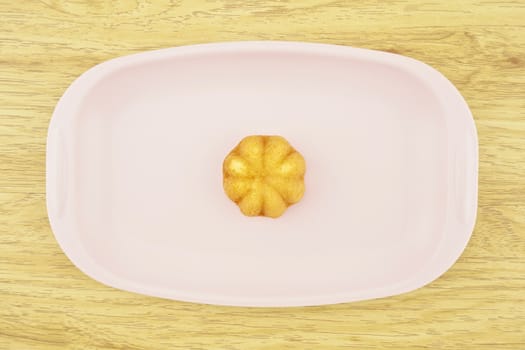 Egg cake is thai bakery put on pink tray with wood background.