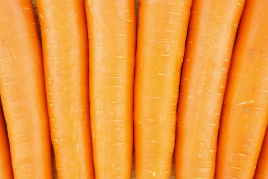 Carrot is orange vegetable with carotene put as texture background.