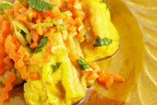 Yellow tofu fried carrot and celery on dish as background.