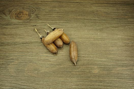 Seed of Thunbergia laurifolia  like pod put on wood background.