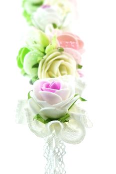 Close up vintage white and pink fabric flower isolated with white background.