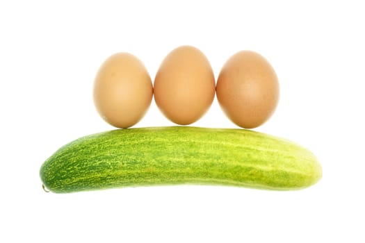 Egg put as straight and cucumber isolated with white background.