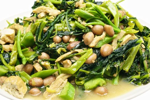 Closeup morning glory and spinach fried with tofu, groundnut and Champignon mushroom.