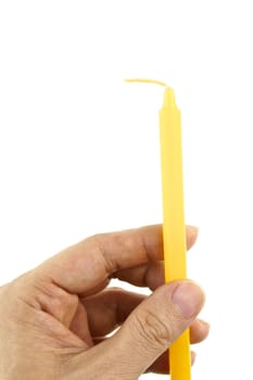 Hand hold yellow candle for lit isolated with white background.