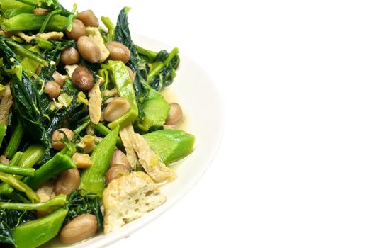 Morning glory and spinach fried with tofu, groundnut and Champignon mushroom isolated with white background.