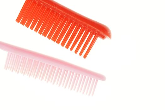 Pink and red comb different size isolated with white background.