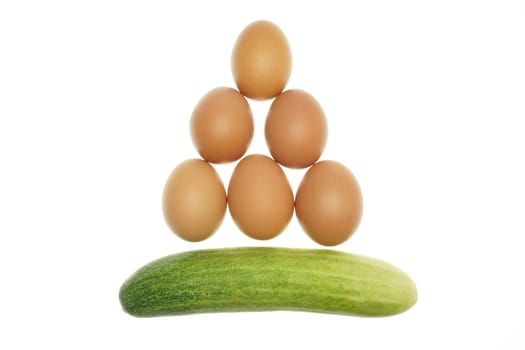 Egg put as triangle and cucumber isolated with white background.