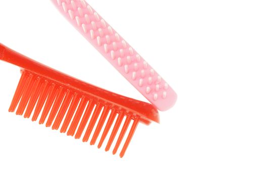 Red and pink comb different size isolated with white background.