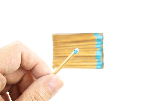 Hand hold blue matchstick for lit and box isolated with white background.