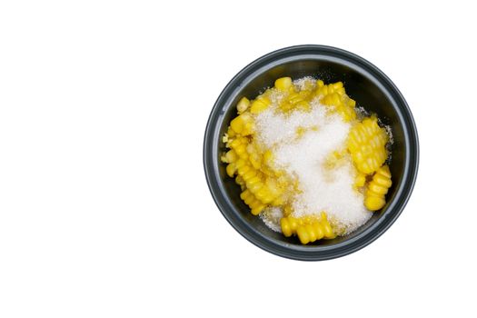 Shear corn with sugar and salt in bowl isolated with white background.