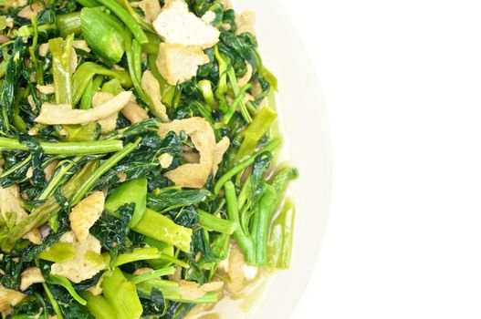 Spinach fried with tofu and Champignon mushroom isolated with white background.