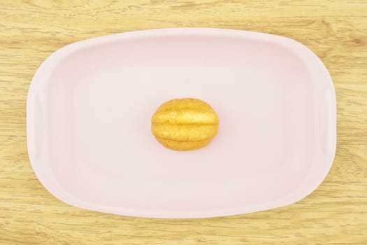 Egg cake is thai bakery put on pink tray with wood background.