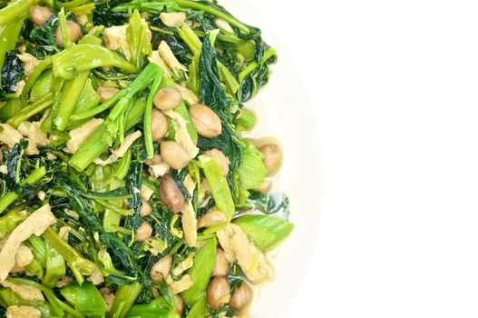 Morning glory and spinach fried with tofu, groundnut and Champignon mushroom isolated with white background.