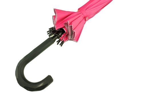 Black handle of pink umbrella closed isolated on white background.