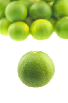 Close up fresh green lemon place isolated on white background.