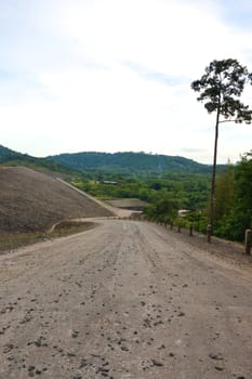 Curve of way down from dam and lake in Thailand.