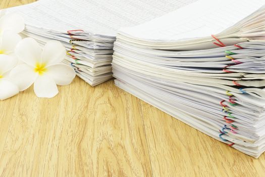 Document of account include sales and receipt place with plumeria on wood background.