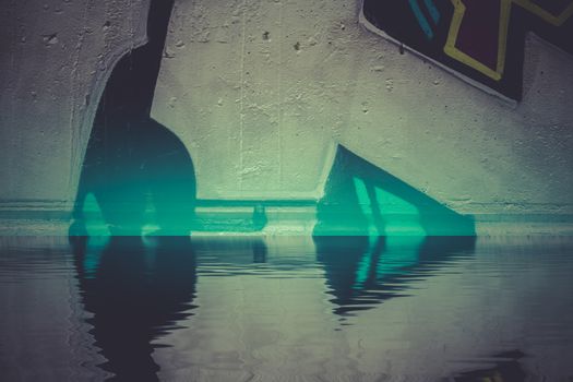 Graffiti reflection in the water, artistic urban arrows