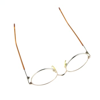 Old glasses for problem vision put upturned isolated with white background.