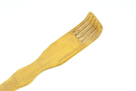 Scratch stick made from bamboo as hand isolated with white background.