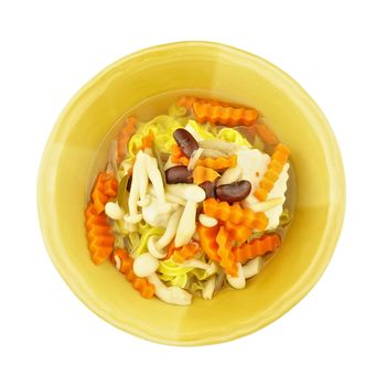 Soup big yellow noodle with tofu, carrot, red bean and shimeji mushroom isolated on white background.