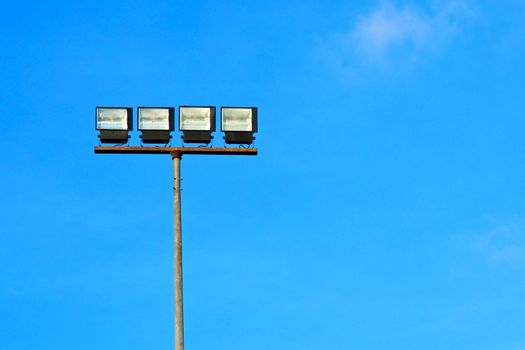 Spotlight halogen for irradiate to the football field with blue sky background.