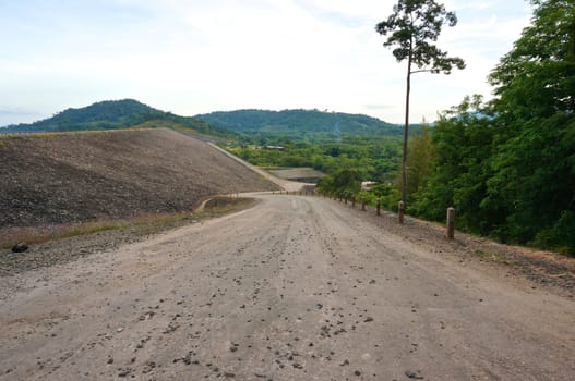 Road of way down from dam and lake in Thailand.