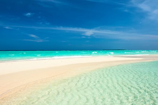 Beautiful island beach with sandspit at Maldives