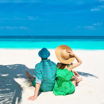 Couple in green on a tropical beach at Maldives