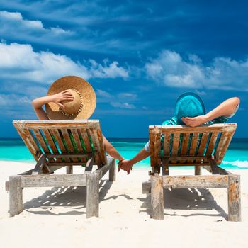 Couple in green on a tropical beach at Maldives