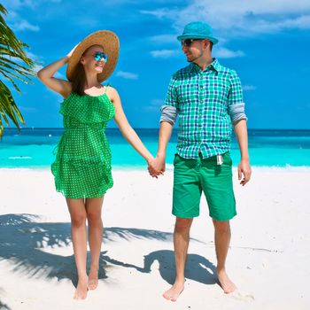 Couple in green on a tropical beach at Maldives