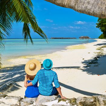 Couple in blue clothes on a tropical beach at Maldives