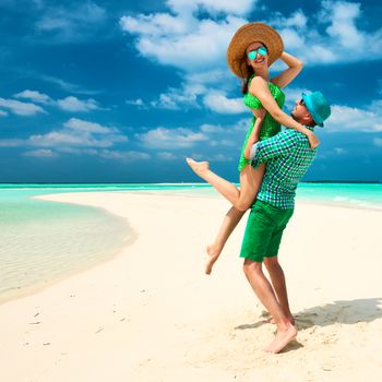 Couple in green on a tropical beach at Maldives