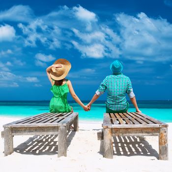 Couple in green on a tropical beach at Maldives