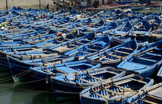 ESSAOUIRA, MOROCCO - MAY 9, 2014: Blue fishing boats in harbour in an abstract pattern on a sunny day. Essaouira, Morocco. May 9, 2014.