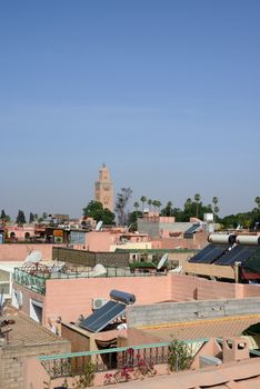 Rooftops in Marrakesh, Morocco with blue sky and solar panels.