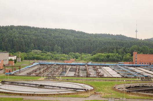 water treatment facility buildings. Sewage water cleaning reservoir. Birds fly.