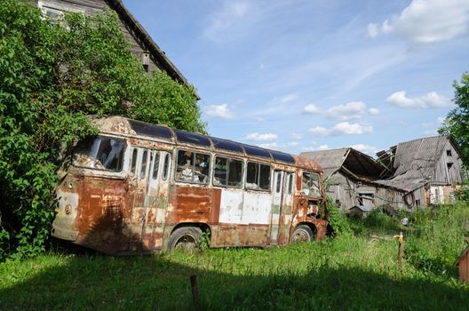 rusty lonely broken mini bus in country green field