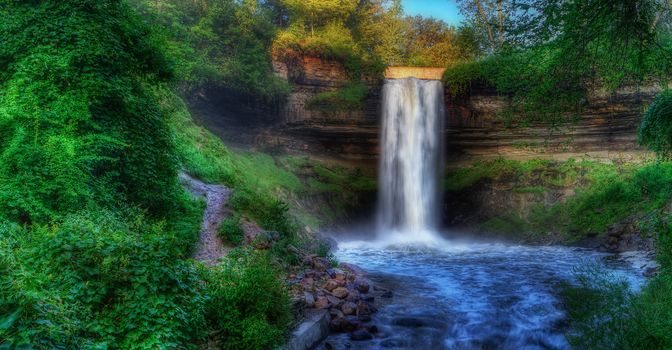 Beautiful Minnehaha Creek Waterfall and downstream river in HDR High Dynamic Range.