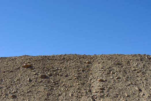Rock mountain cliff over blue sky background