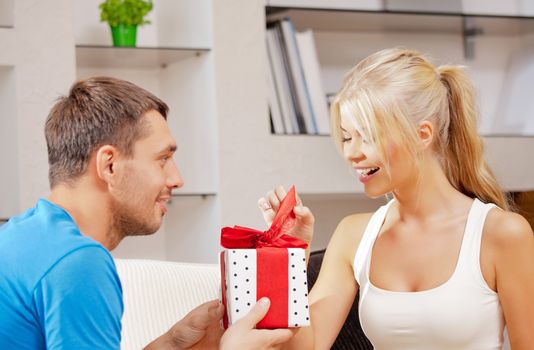 bright picture of happy romantic couple with gift (focus on woman)